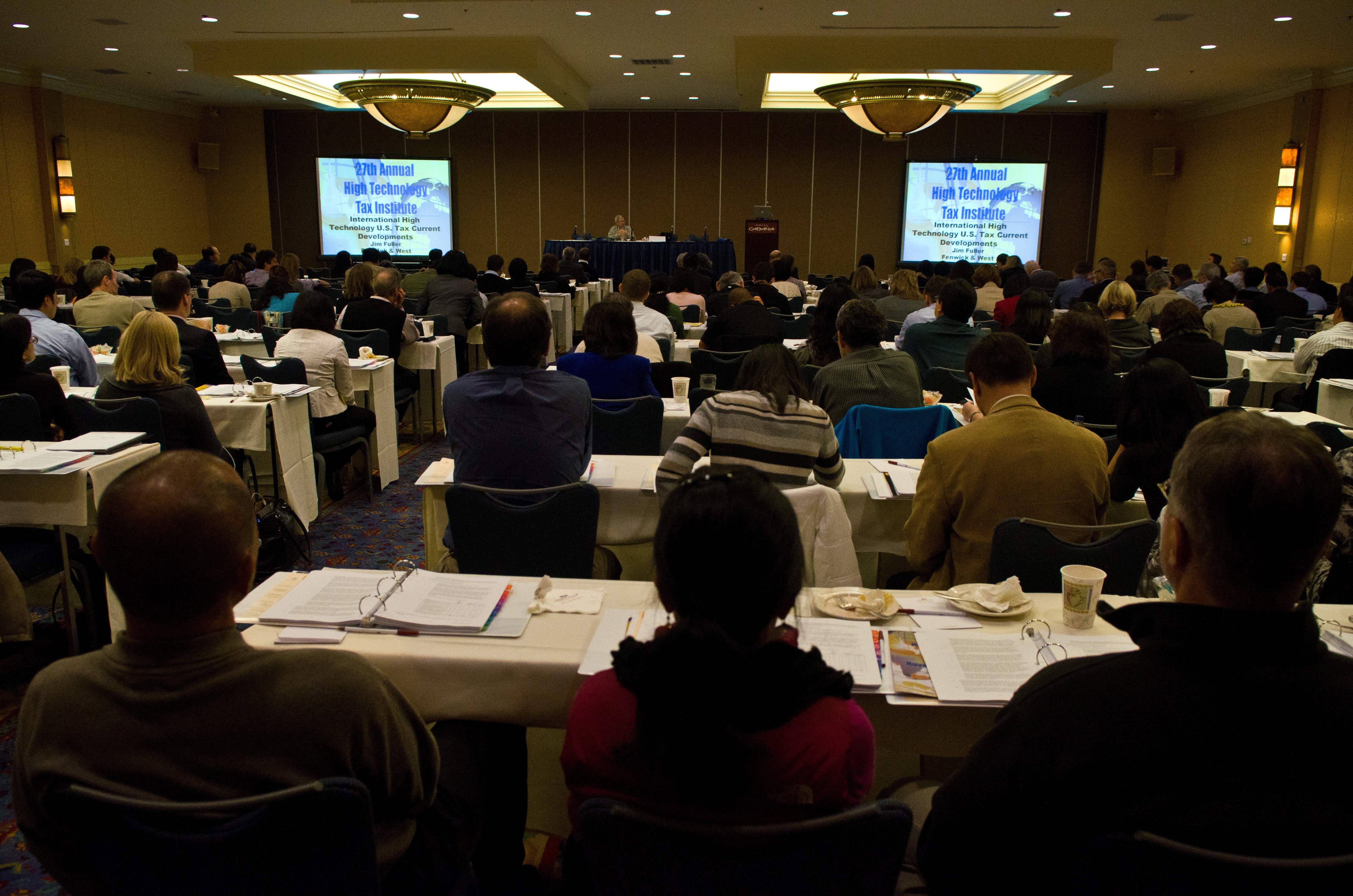 Image of tax professor speaking to group.